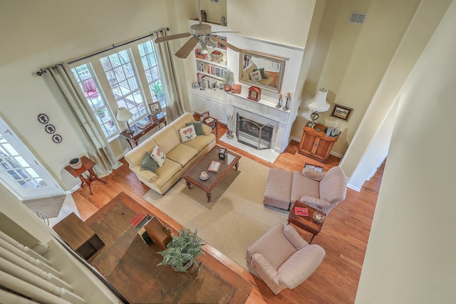 living room featuring light hardwood / wood-style flooring and a high ceiling