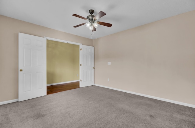 unfurnished bedroom with ceiling fan and carpet floors