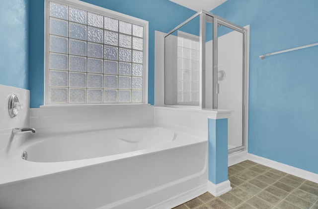 bathroom featuring shower with separate bathtub