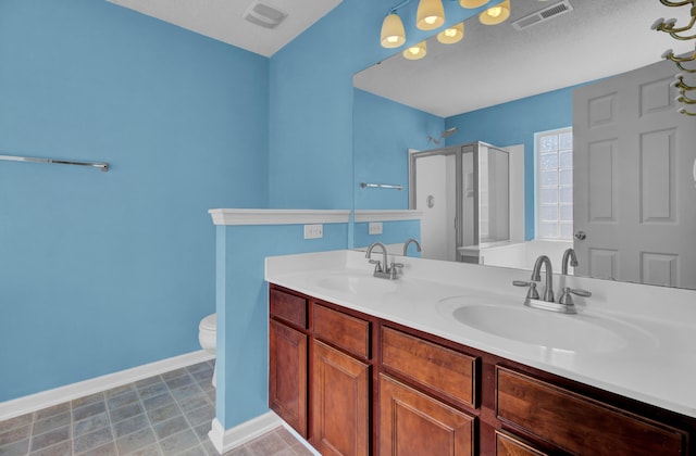 bathroom featuring walk in shower, vanity, and toilet