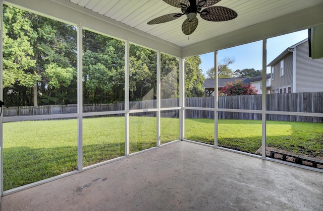 unfurnished sunroom with ceiling fan