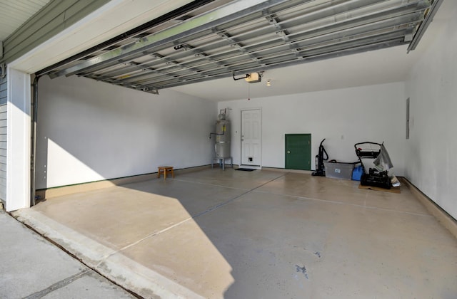 garage with strapped water heater and a garage door opener