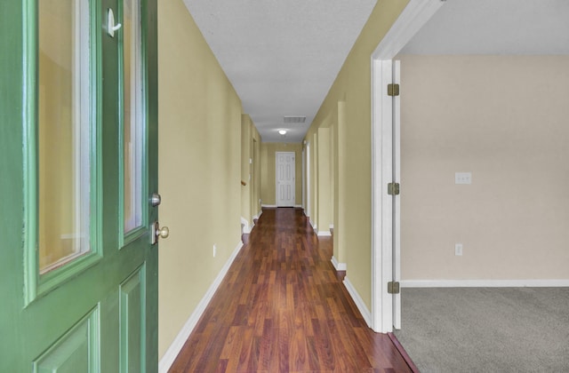 corridor with dark hardwood / wood-style floors