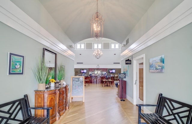 hallway with vaulted ceiling, light wood-type flooring, and a chandelier