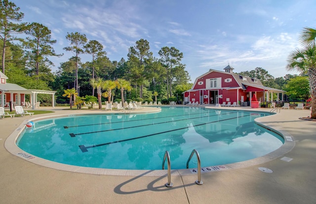 view of swimming pool featuring a pergola and a patio