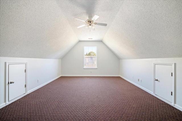 additional living space featuring ceiling fan, a textured ceiling, lofted ceiling, and carpet floors