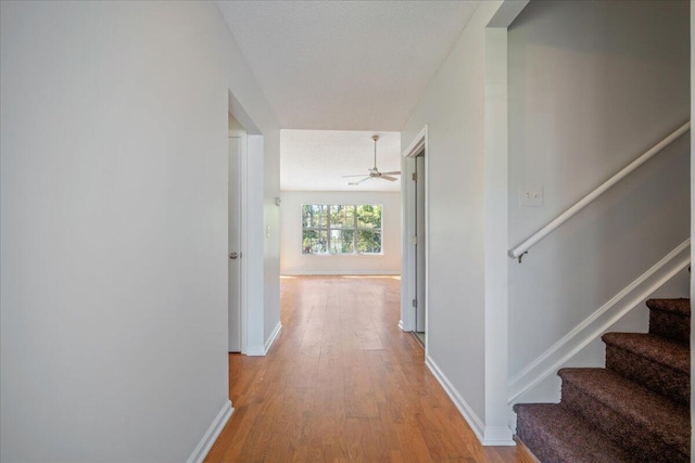 corridor with light wood-type flooring