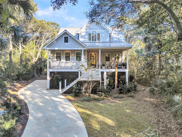 view of front of property with covered porch and a front yard