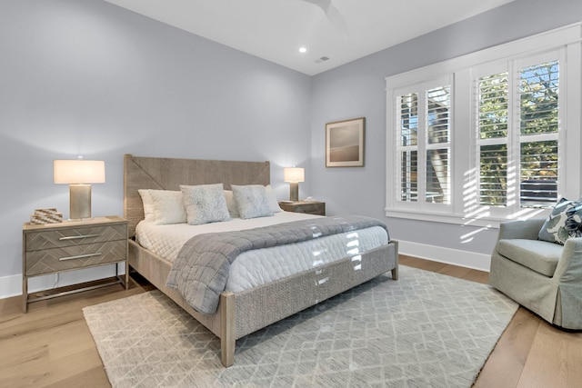 bedroom with hardwood / wood-style flooring and ceiling fan