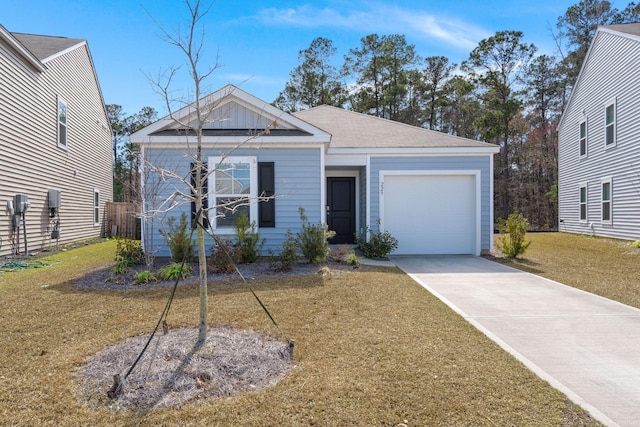 view of front of property featuring an attached garage, a front lawn, and concrete driveway