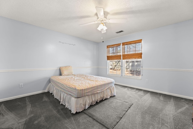 bedroom featuring a textured ceiling, carpet floors, visible vents, and baseboards