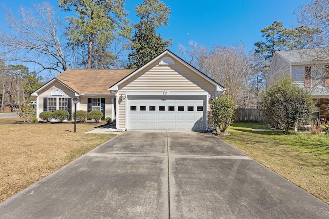 view of front of home with a garage, a front yard, driveway, and fence