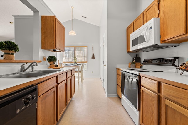 kitchen with decorative light fixtures, light countertops, vaulted ceiling, a sink, and white appliances