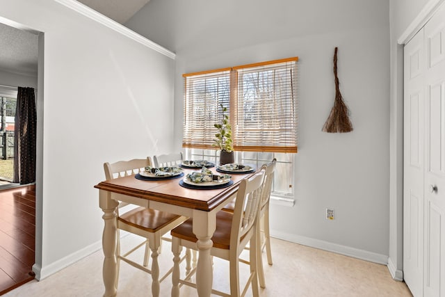 dining area featuring baseboards and a textured ceiling