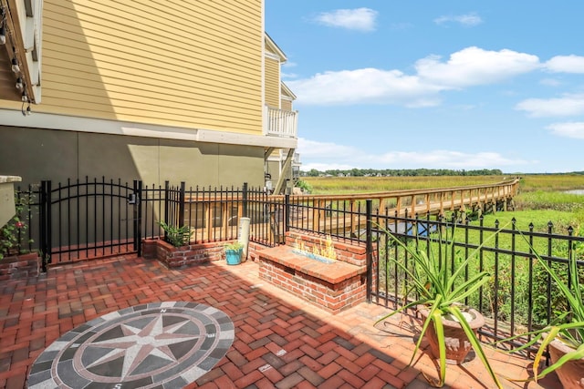 view of patio / terrace with a gate, a rural view, and fence