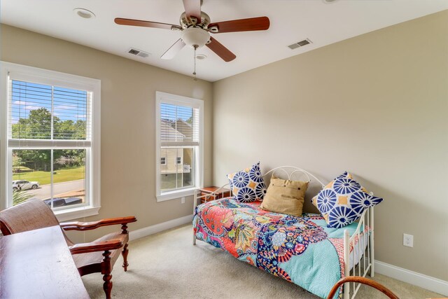 bedroom featuring carpet, visible vents, and multiple windows