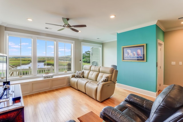 living area with ornamental molding, light wood-type flooring, visible vents, and recessed lighting