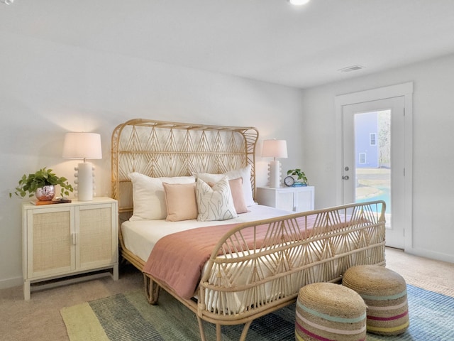 bedroom with light carpet, visible vents, and baseboards