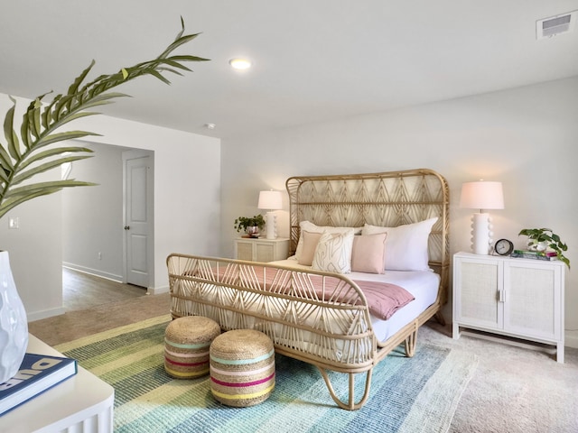 carpeted bedroom with baseboards and visible vents