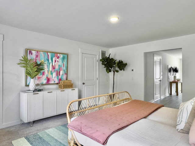 carpeted bedroom featuring radiator and baseboards