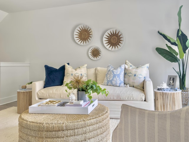 living area featuring baseboards and wood finished floors