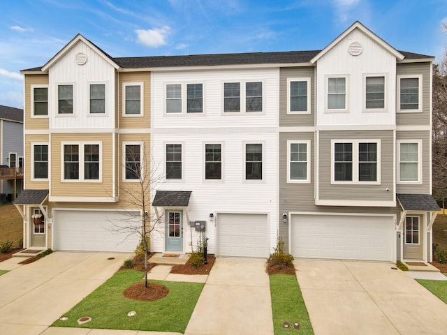 townhome / multi-family property featuring board and batten siding, driveway, a shingled roof, and a garage