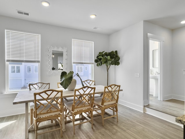 dining space featuring light wood-type flooring, visible vents, baseboards, and recessed lighting