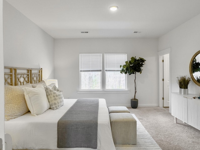 carpeted bedroom with baseboards and visible vents