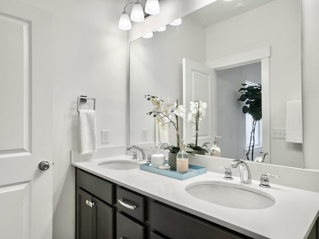 bathroom featuring a sink and double vanity