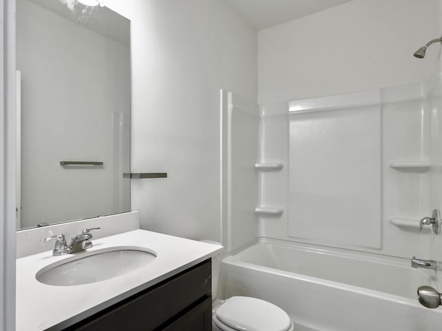 bathroom with bathtub / shower combination, vanity, and toilet