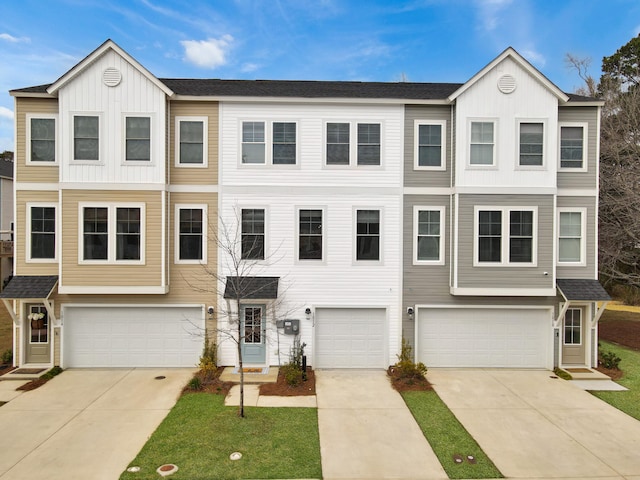 townhome / multi-family property featuring concrete driveway, board and batten siding, and an attached garage