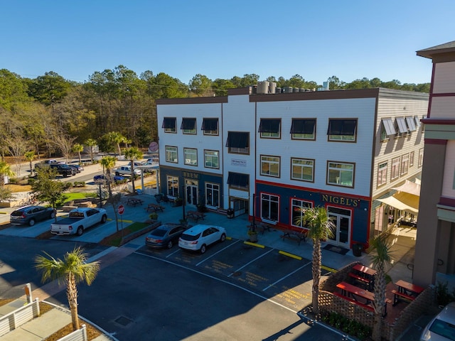 view of property featuring uncovered parking