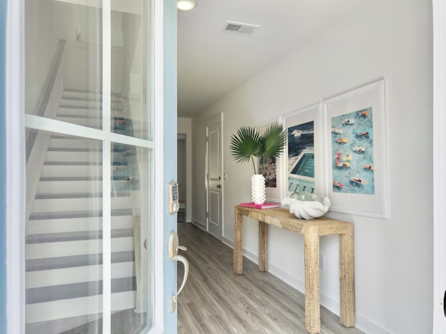 interior space featuring baseboards, visible vents, and wood finished floors