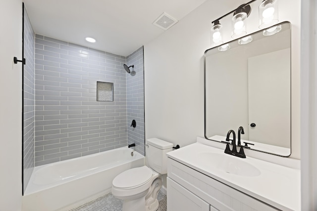 full bathroom with vanity, tiled shower / bath combo, and toilet