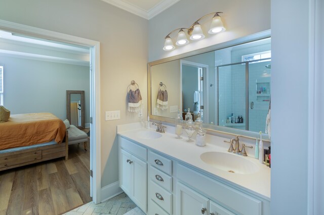 bathroom with a shower with door, ornamental molding, hardwood / wood-style flooring, and vanity