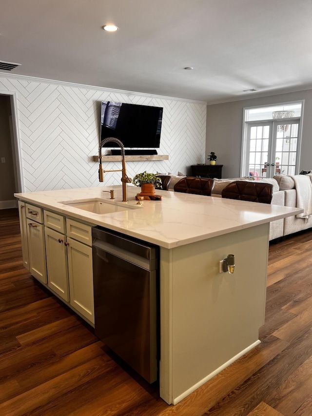 kitchen featuring sink, a center island with sink, dark hardwood / wood-style flooring, dishwasher, and light stone countertops