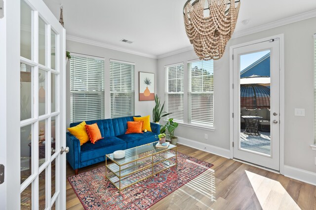 living room with crown molding and wood-type flooring