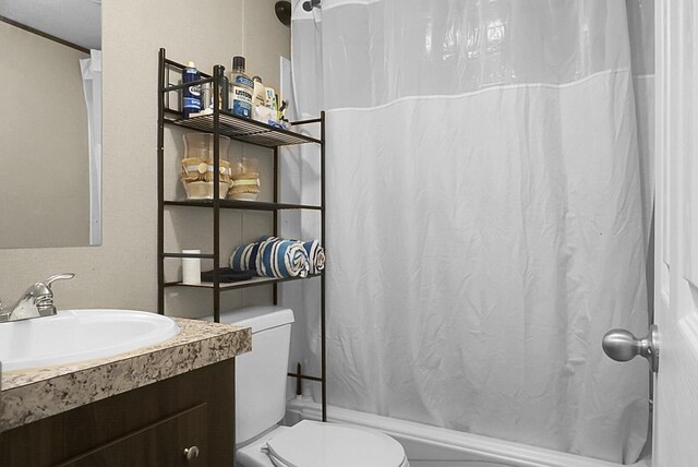 bathroom featuring crown molding, oversized vanity, and toilet