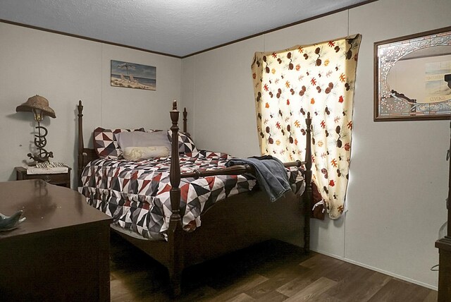 bedroom featuring dark wood-type flooring and a textured ceiling