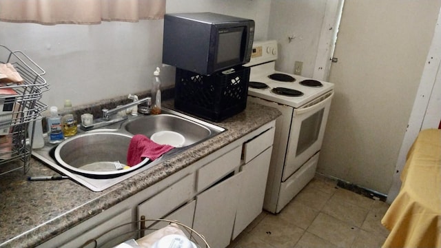 kitchen featuring white cabinetry, white electric range oven, light tile patterned flooring, and sink