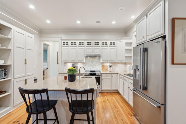 kitchen featuring light wood-type flooring, white cabinetry, appliances with stainless steel finishes, open shelves, and ornamental molding
