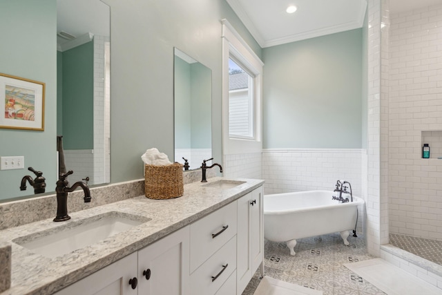 bathroom featuring ornamental molding, a soaking tub, a sink, and double vanity