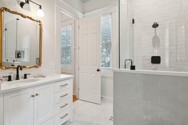bathroom with vanity, marble finish floor, a stall shower, and a wealth of natural light