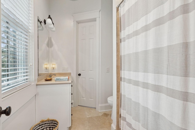 bathroom featuring a shower with curtain, vanity, tile patterned flooring, and toilet