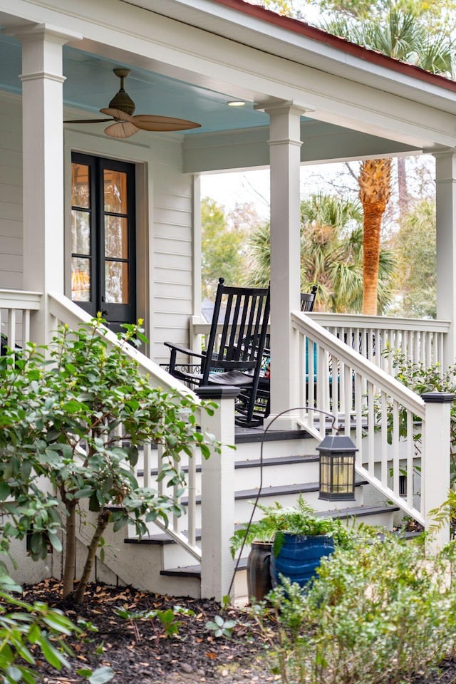 deck with ceiling fan, covered porch, and stairs