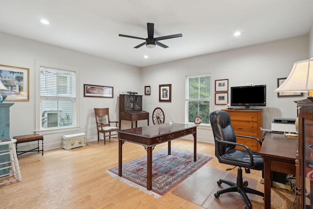 home office featuring ceiling fan, baseboards, and light wood-style floors