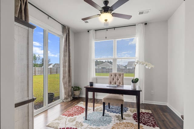 home office with ceiling fan and dark hardwood / wood-style flooring