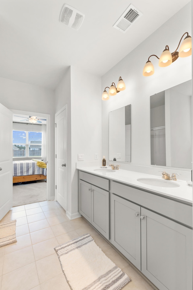 bathroom with ceiling fan, vanity, and tile patterned floors