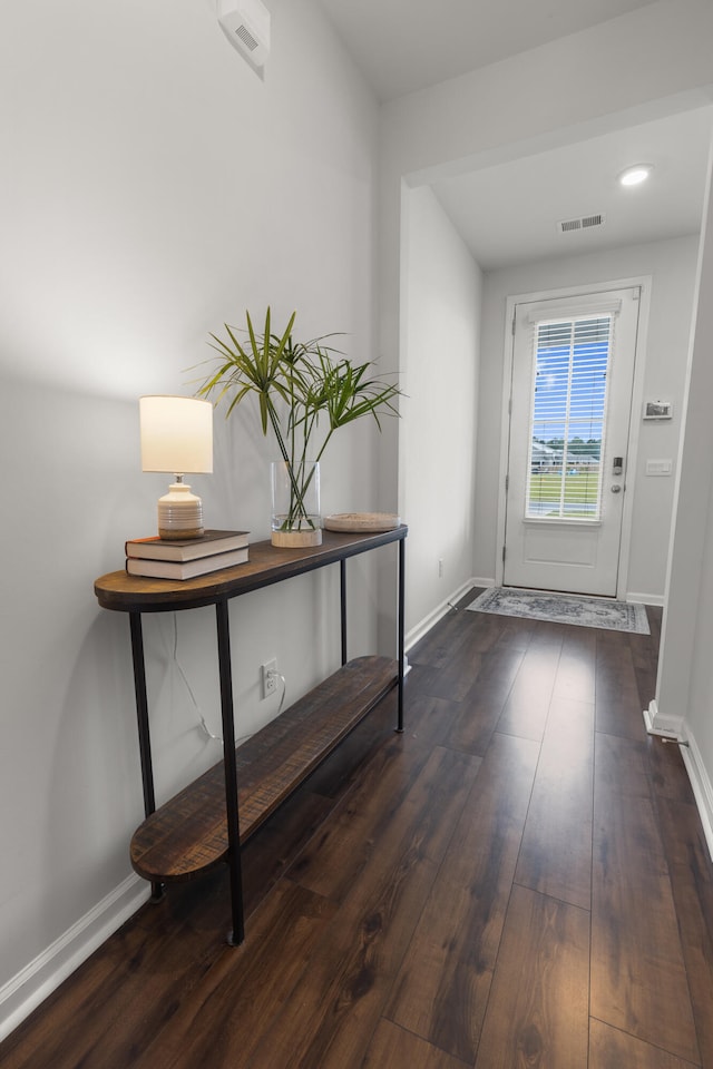 doorway with dark wood-type flooring