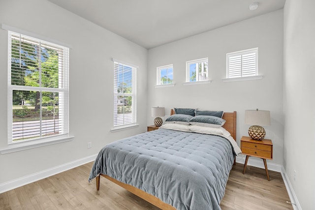 bedroom featuring light wood-style flooring and baseboards